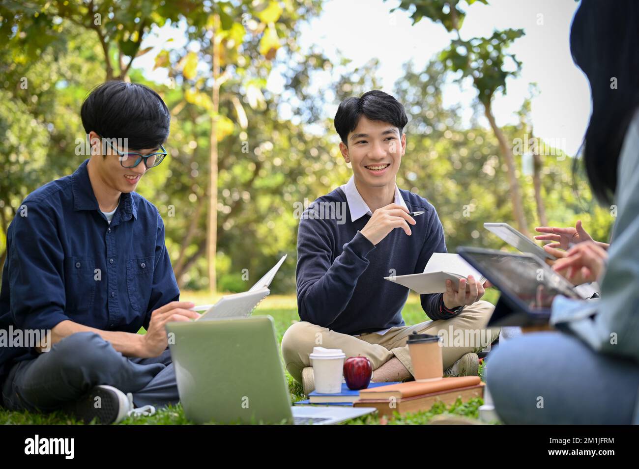 Happy young Asian male college student is having a great time with his ...