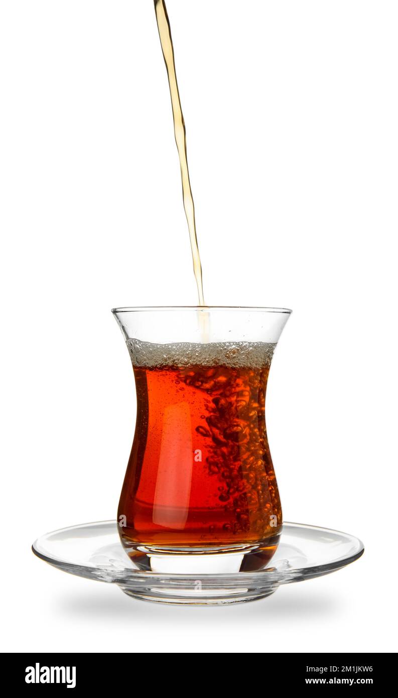 Pouring of Turkish tea into glass on white background Stock Photo Alamy