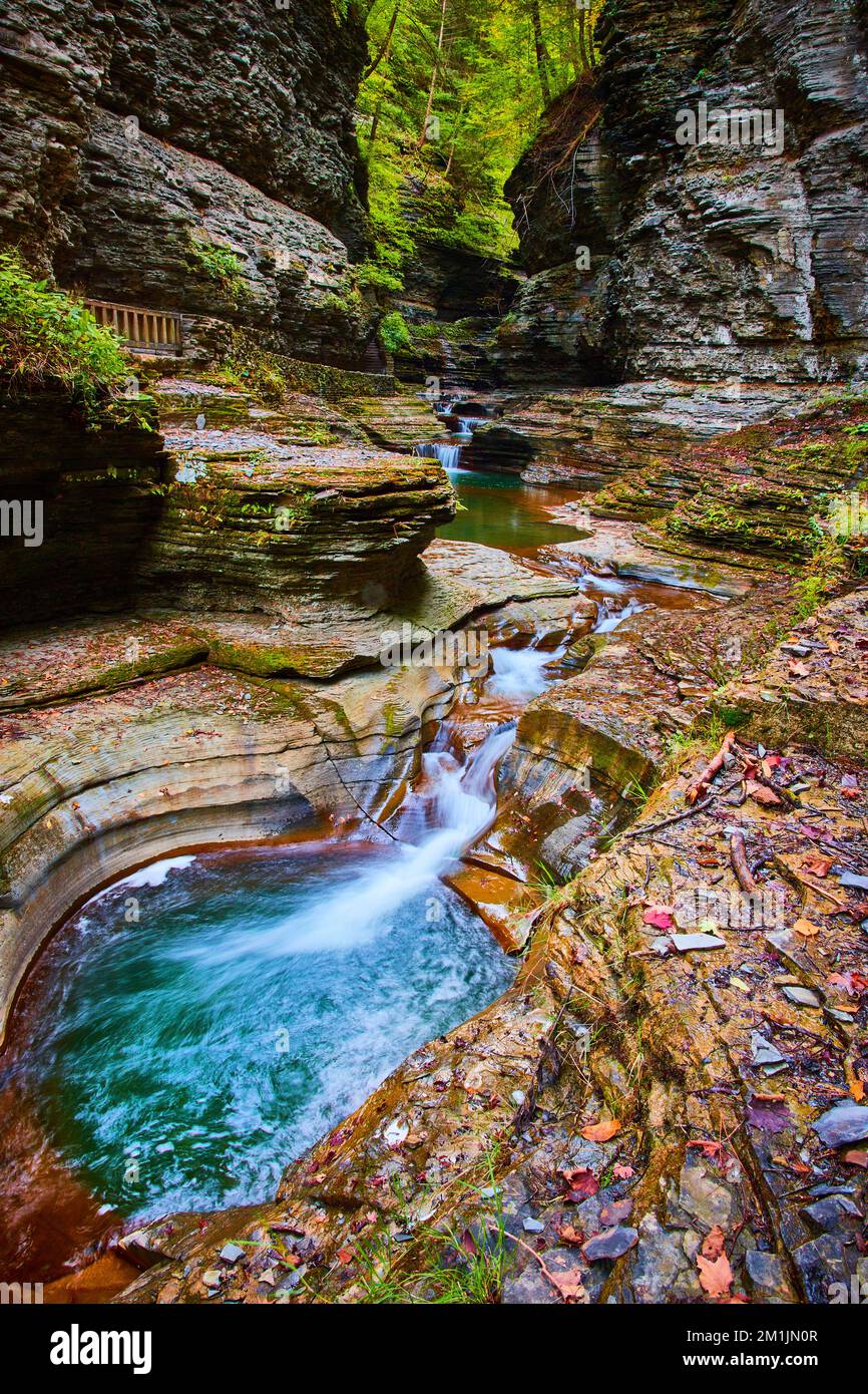 Small waterfalls along stunning blue river in gorge of New York with ...