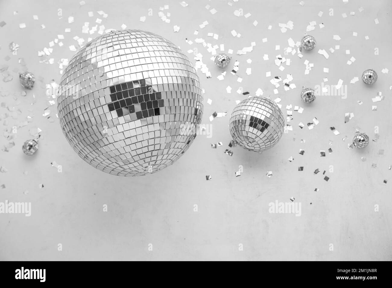 Disco balls with confetti on grey background Stock Photo Alamy
