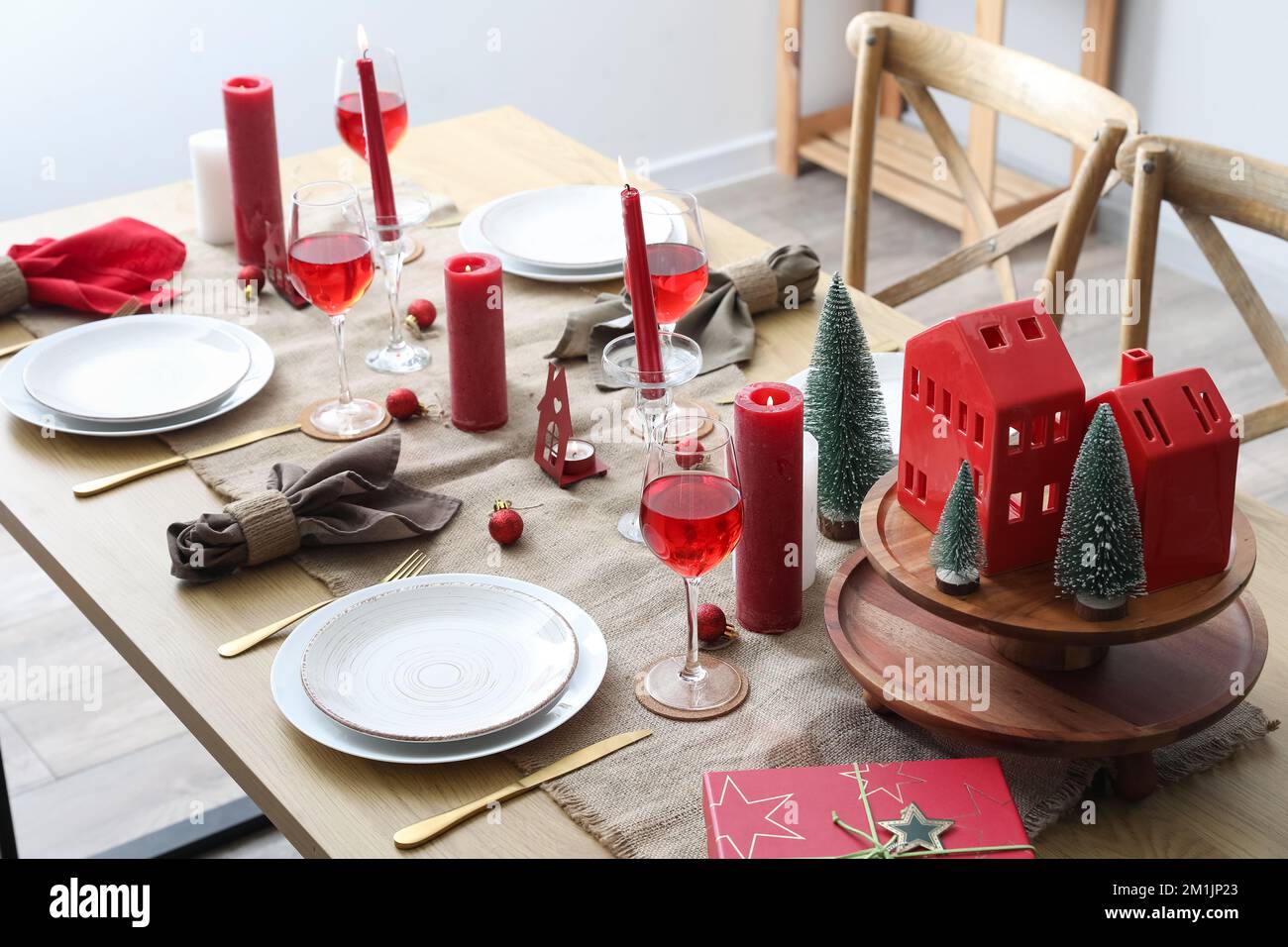 Table setting with candles and Christmas trees in dining room Stock ...