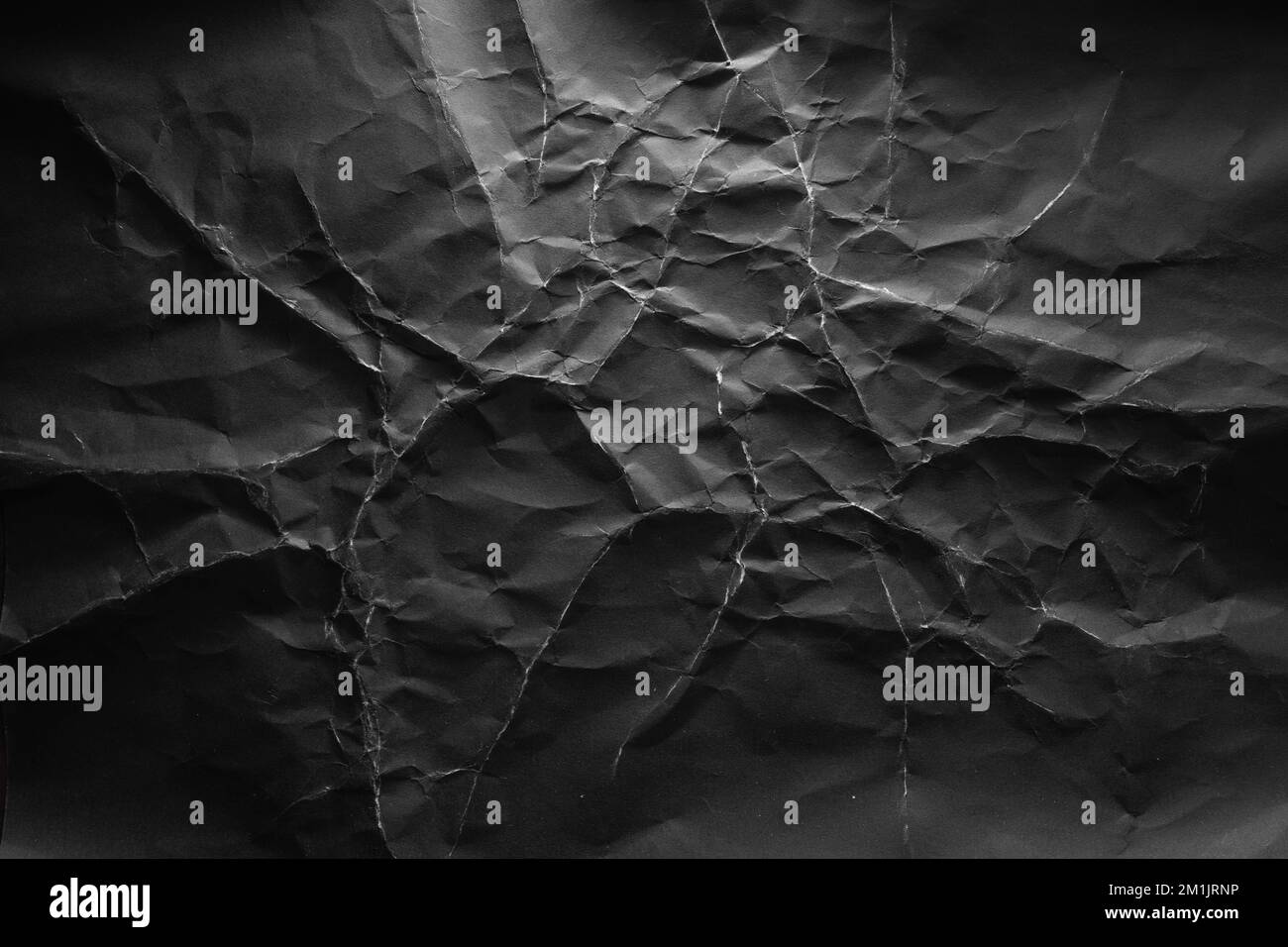 Black crumpled paper with lightning-like texture background Stock Photo