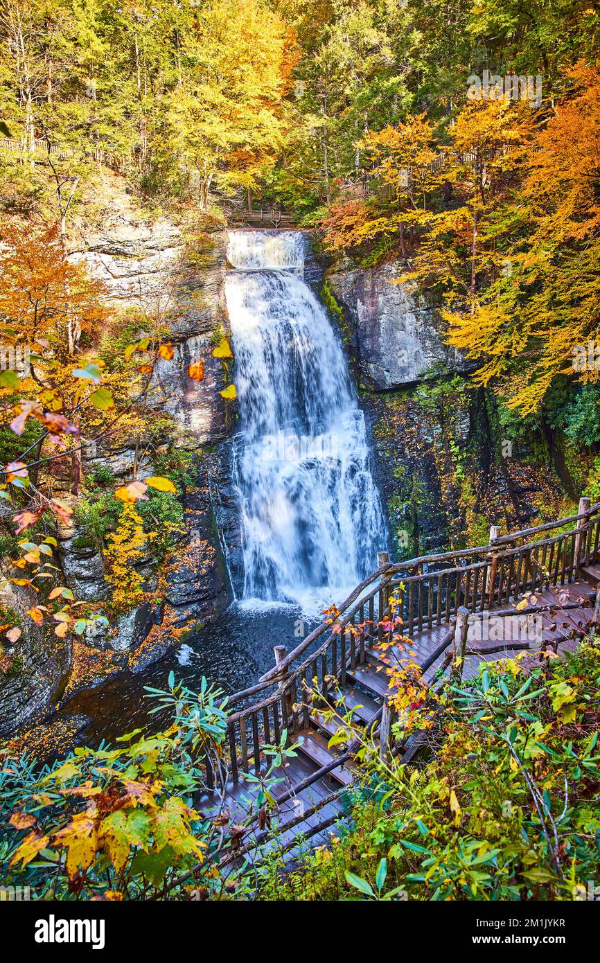 Stunning boardwalk along huge raging waterfall over cliffs surrounded ...