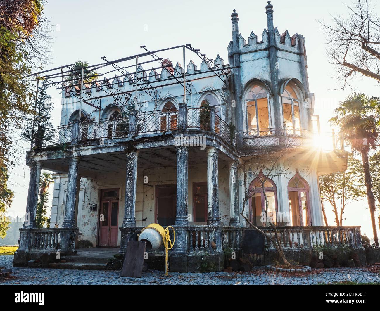 Facade of old vintage haunted castle or mansion on sunny summer day. Stock Photo