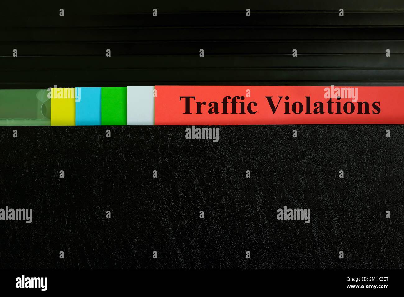 Hand picking traffic violations file record in black binder folder. Civil offenses concept. Stock Photo