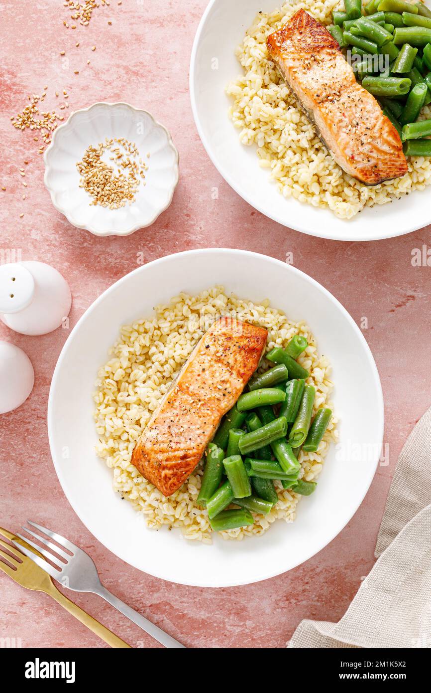 Salmon fillet grilled with bulgur and green beans. Healthy food, diet. Top view Stock Photo