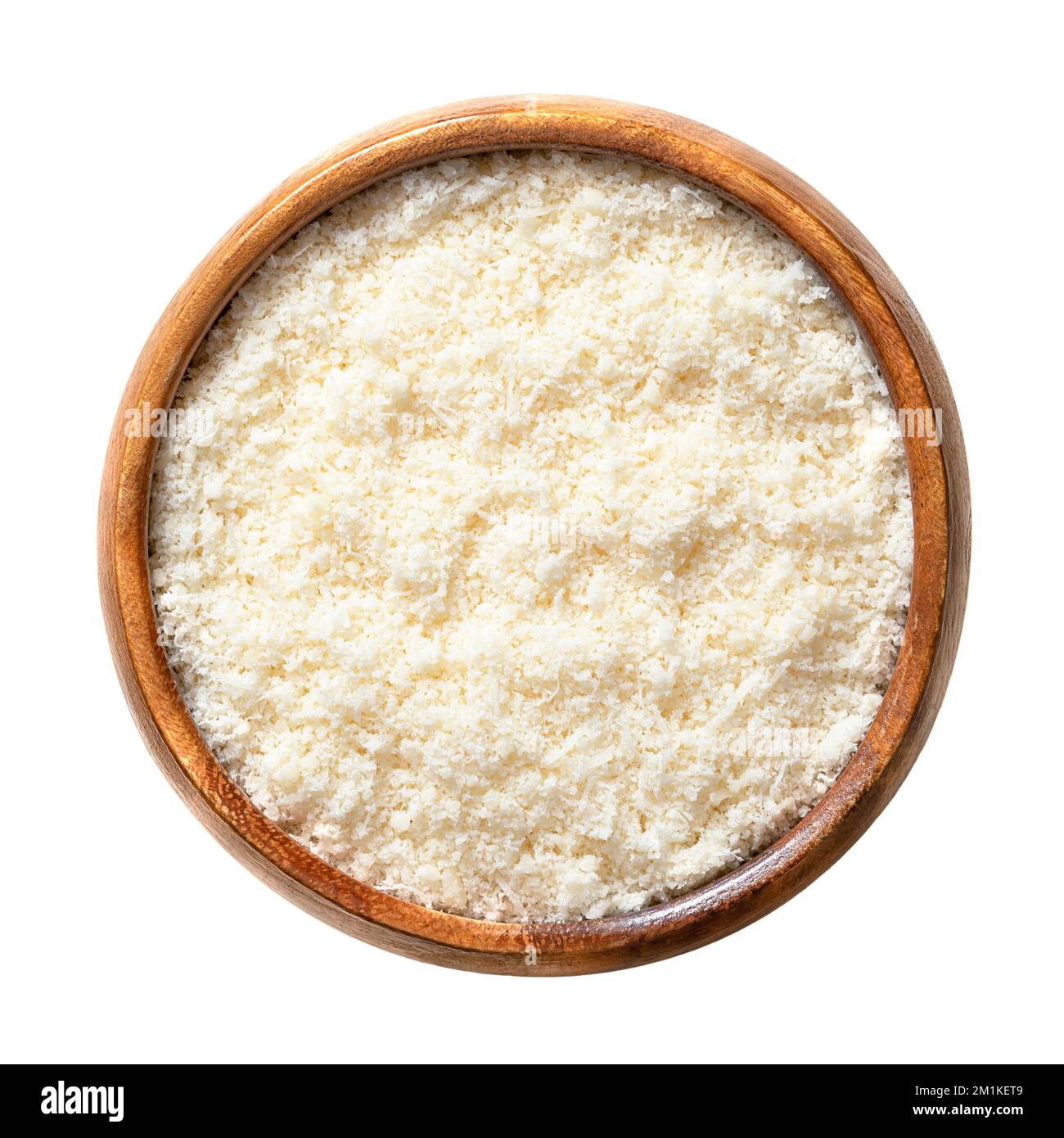 Grated Grana Padano cheese, in a wooden bowl. Italian hard cheese, similar to Parmesan, with strong savory flavor and slightly gritty texture. Stock Photo