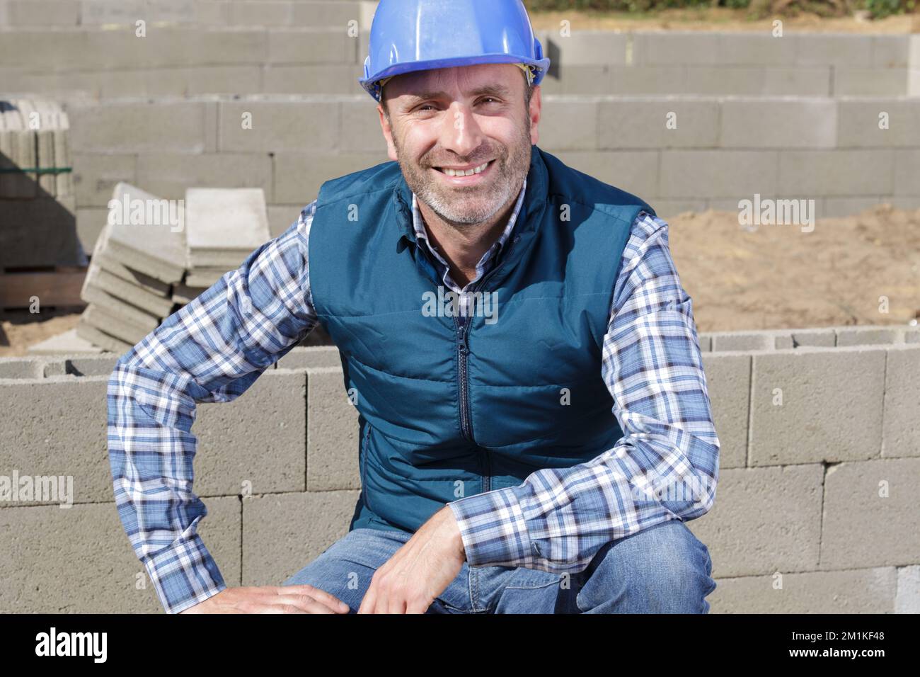 construction worker posing with bricks on white Stock Photo