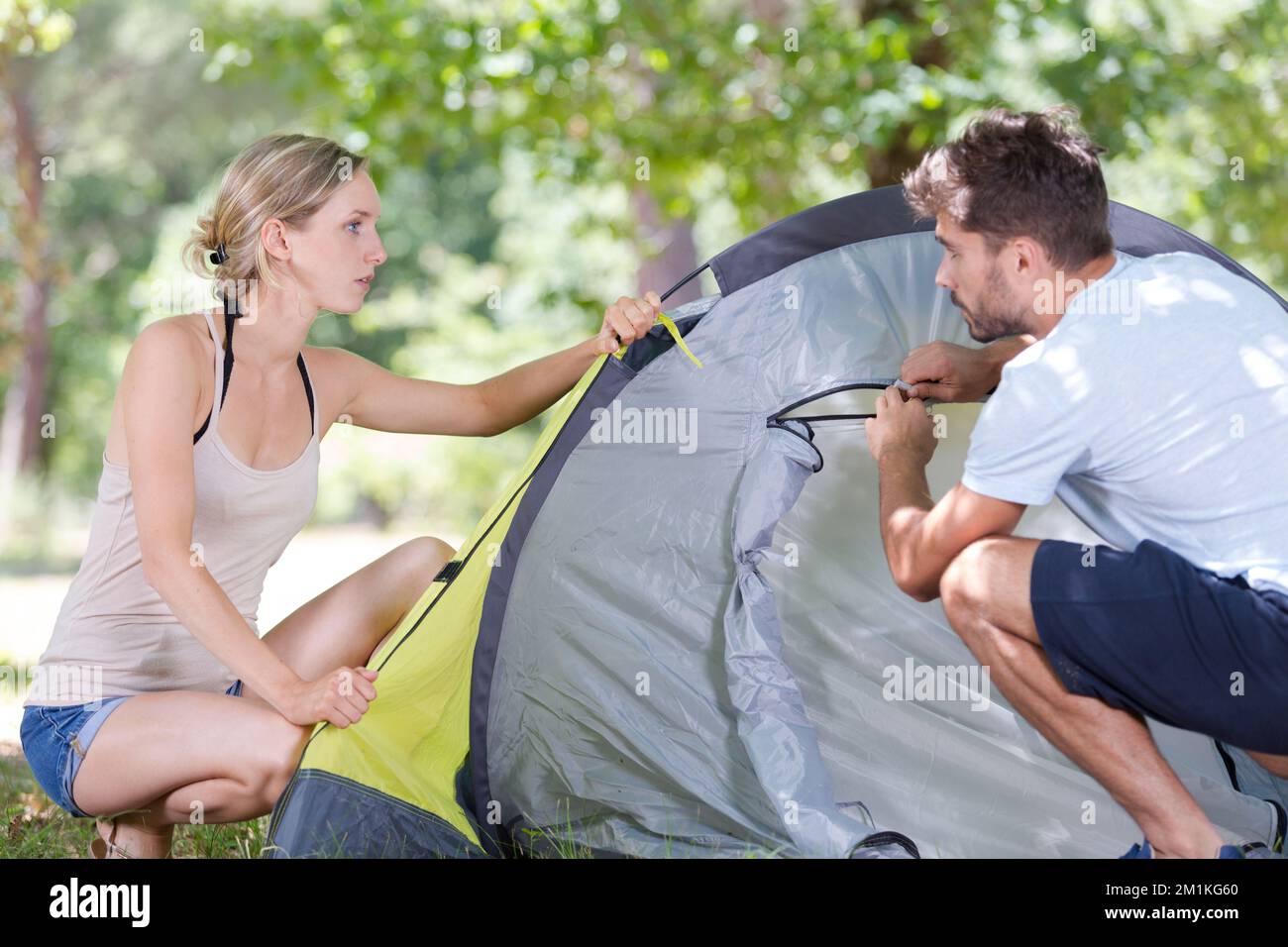 a happy couple is camping Stock Photo