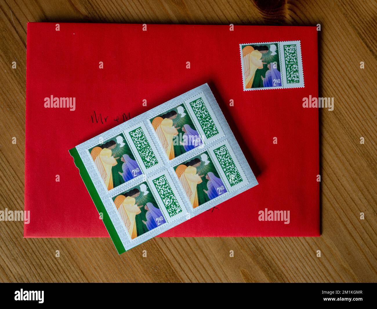 Second class Christmas postage stamps with one on a Christmas card
