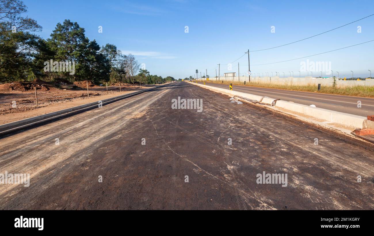 Road highway construction expansion dual road improvement new asphalt tar expanding countryside traffic route. Stock Photo
