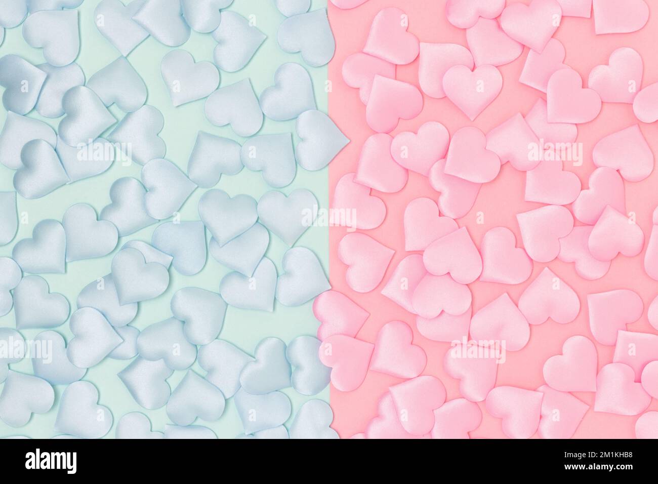 Gender reveal concept with confetti in a hearts shape on a pink and