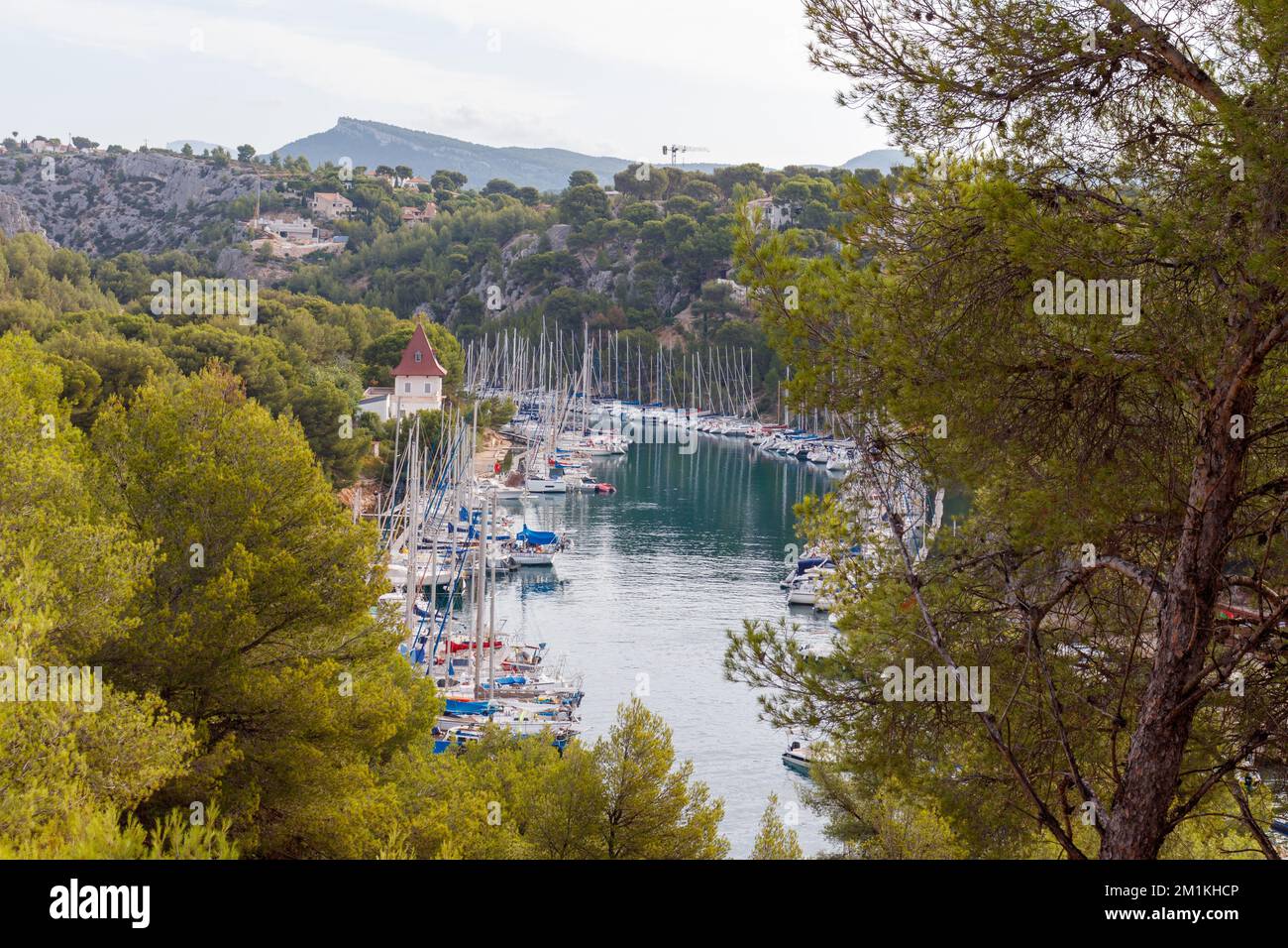 Port-Miou in Cassis France with ships and boats harbouring in blue ocean water. Stock Photo