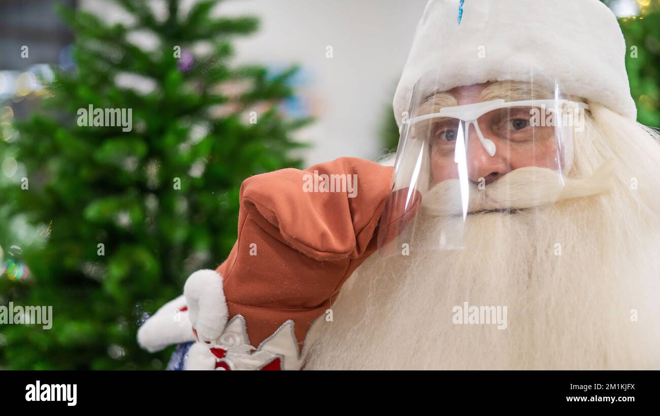 Portrait of russian santa claus in a protective visor. Stock Photo