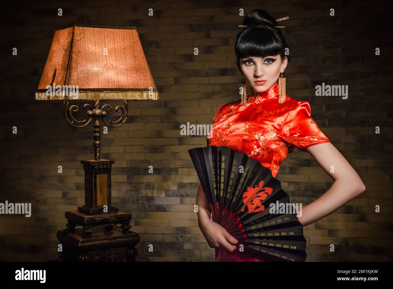 girl in a red Japanese silk dress qipao in a dark atmospheric room