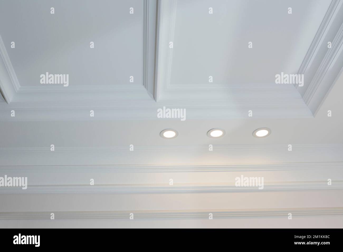 Ornamental white molding decor on ceiling. Ceiling moldings in the