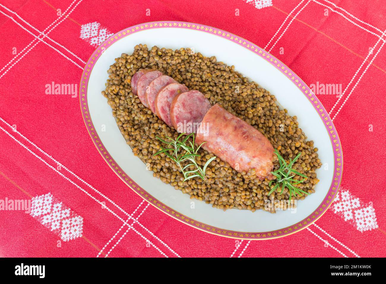 Cotechino (pork sausage) with lentils. Traditional Italian dish Stock
