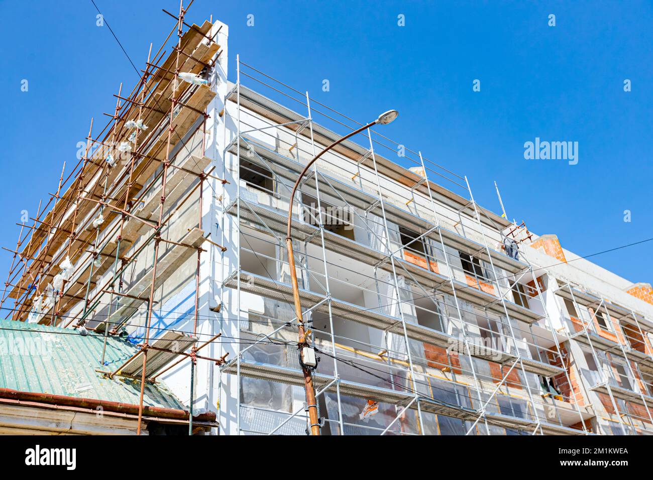 View on unfinished residential edifice, installation of Styrofoam, heat ...