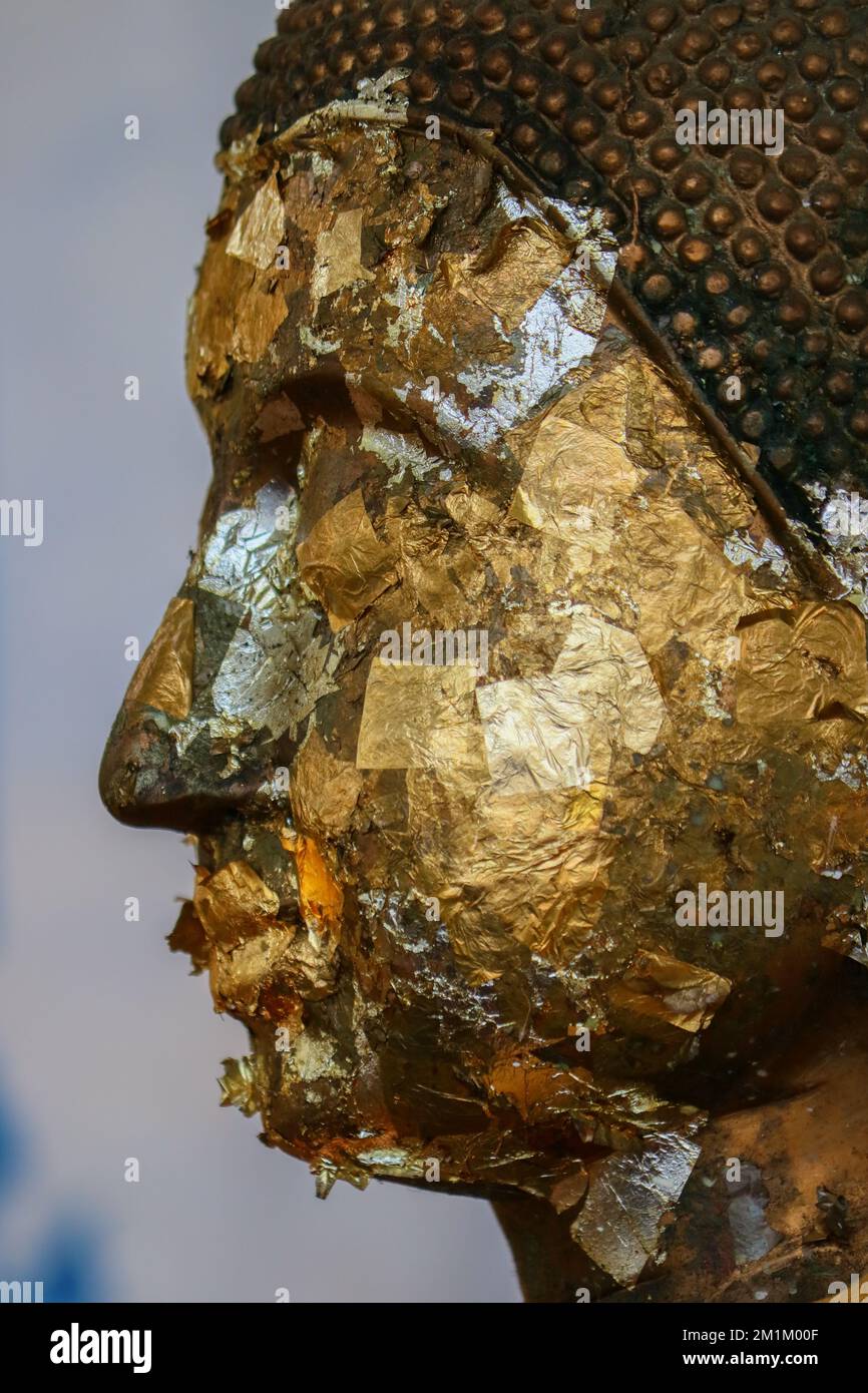 Buddha statue surface by gold leaf gilding, Thai style make merit Stock Photo