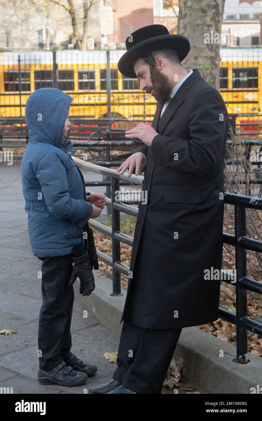 During recess at a Brooklyn yeshiva and student gets one on one time with his rabbi teacher. In Brooklyn, New York. Stock Photo