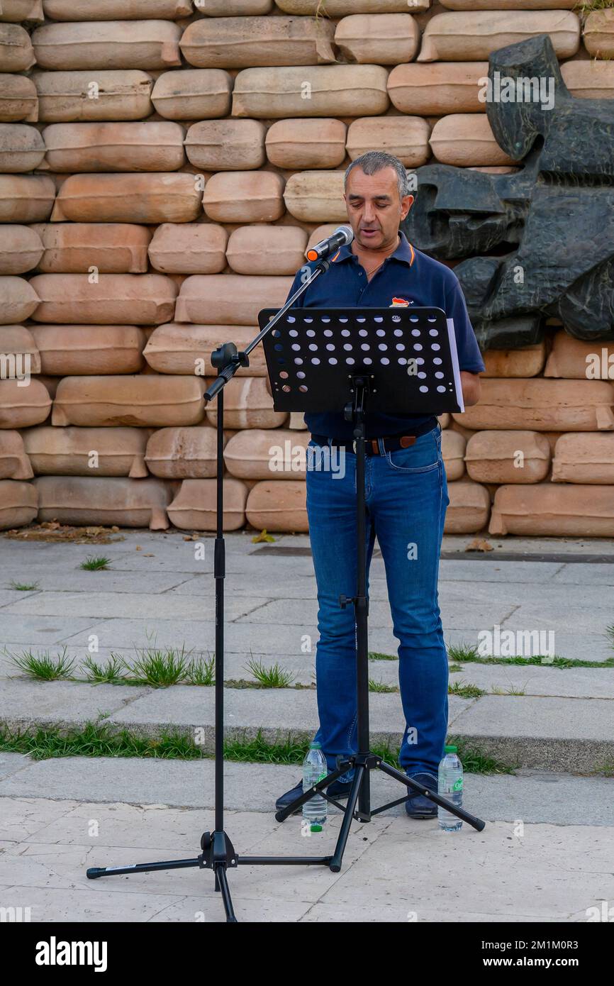 A man publicly speaks to a small group of people protesting the Democratic Memory Law Stock Photo