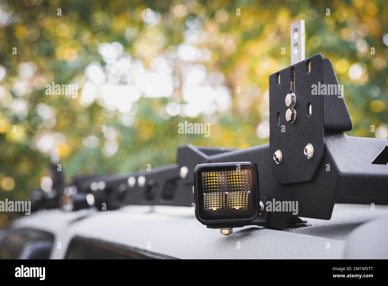 Custom LED side light bar on roof rack off road car, copy space Stock