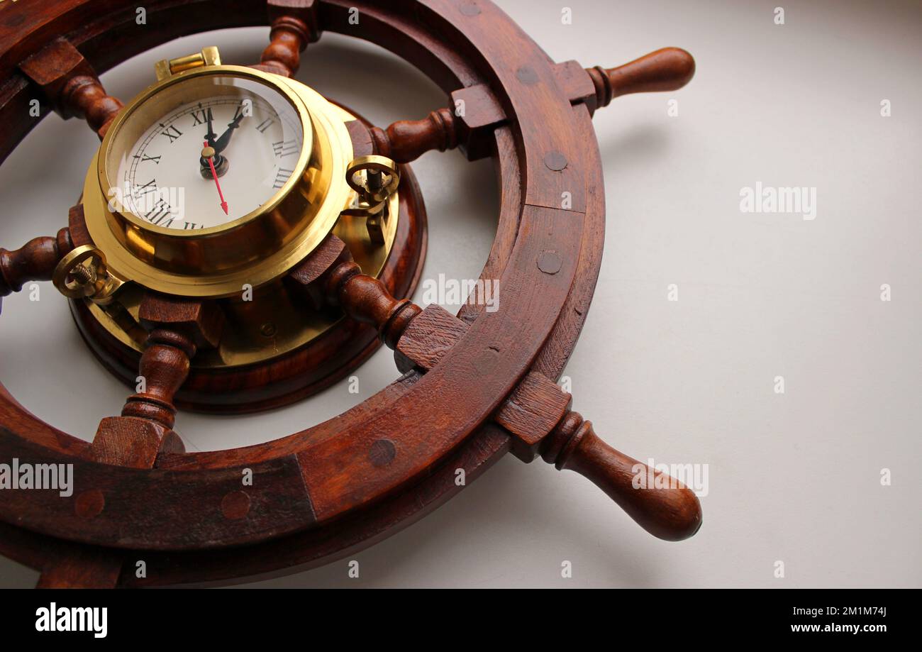 Sailboat Helm Made From Red Wood With Copper Frame Clock On White Background Stock Photo