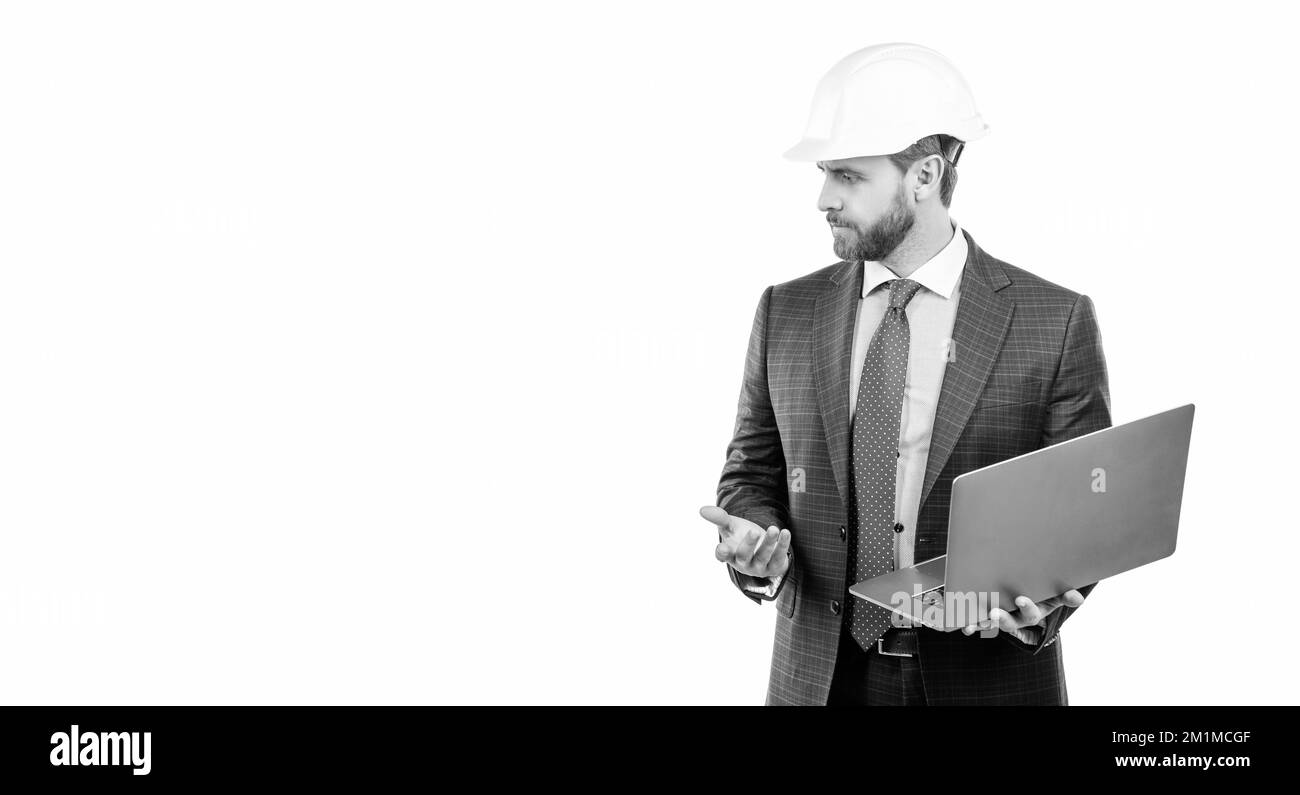 Serious engineer man in hardhat and suit use laptop computer for ...