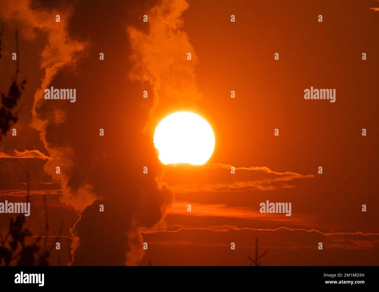 smoke factory sunrise big sun clouds zoom Stock Photo - Alamy