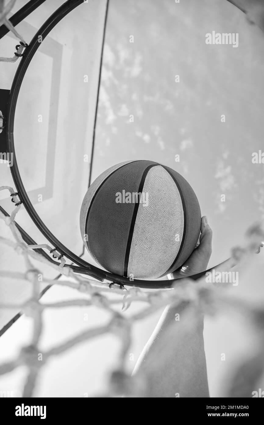 basketball player throws the ball into the hoop, closeup, sport success Stock Photo