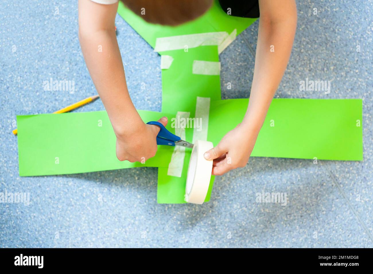 School child constructing with card scissors and tape Stock Photo