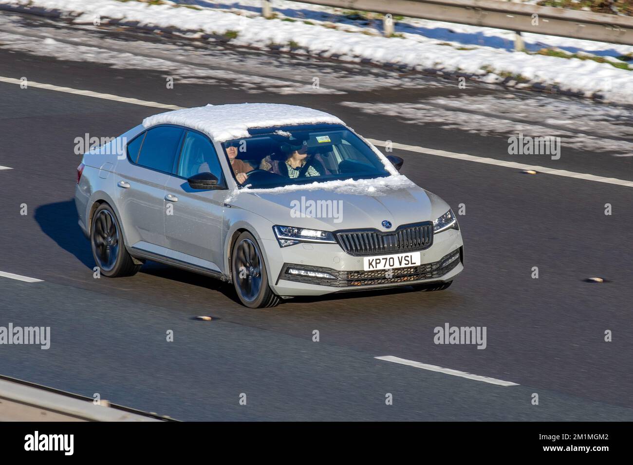 2020 Grey SKODA SUPERB SPORTLINE PLUS TDI DSG 1968cc Diesel 7 speed Semi-Auto; Cars travelling on a cold winter morning. Wintertime low temperatures with December frost and cold driving conditions on the M61 motorway, UK Stock Photo