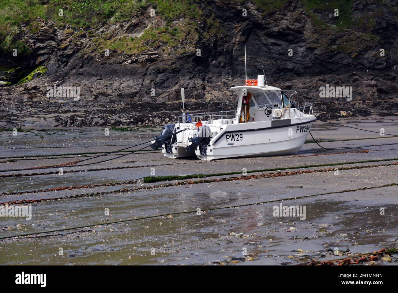 Single Small Fishing Boat in the Harbour of the Small Village of Port Isaac on the South West Coastal Path, Cornwall, England, UK. Stock Photo