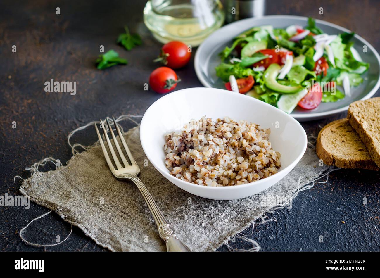 hot Buckwheat porridge with melting butter in plate andHealthy vegetarian  salad of fresh vegetables for lanch on table, top view, copy space Healthy  f Stock Photo - Alamy