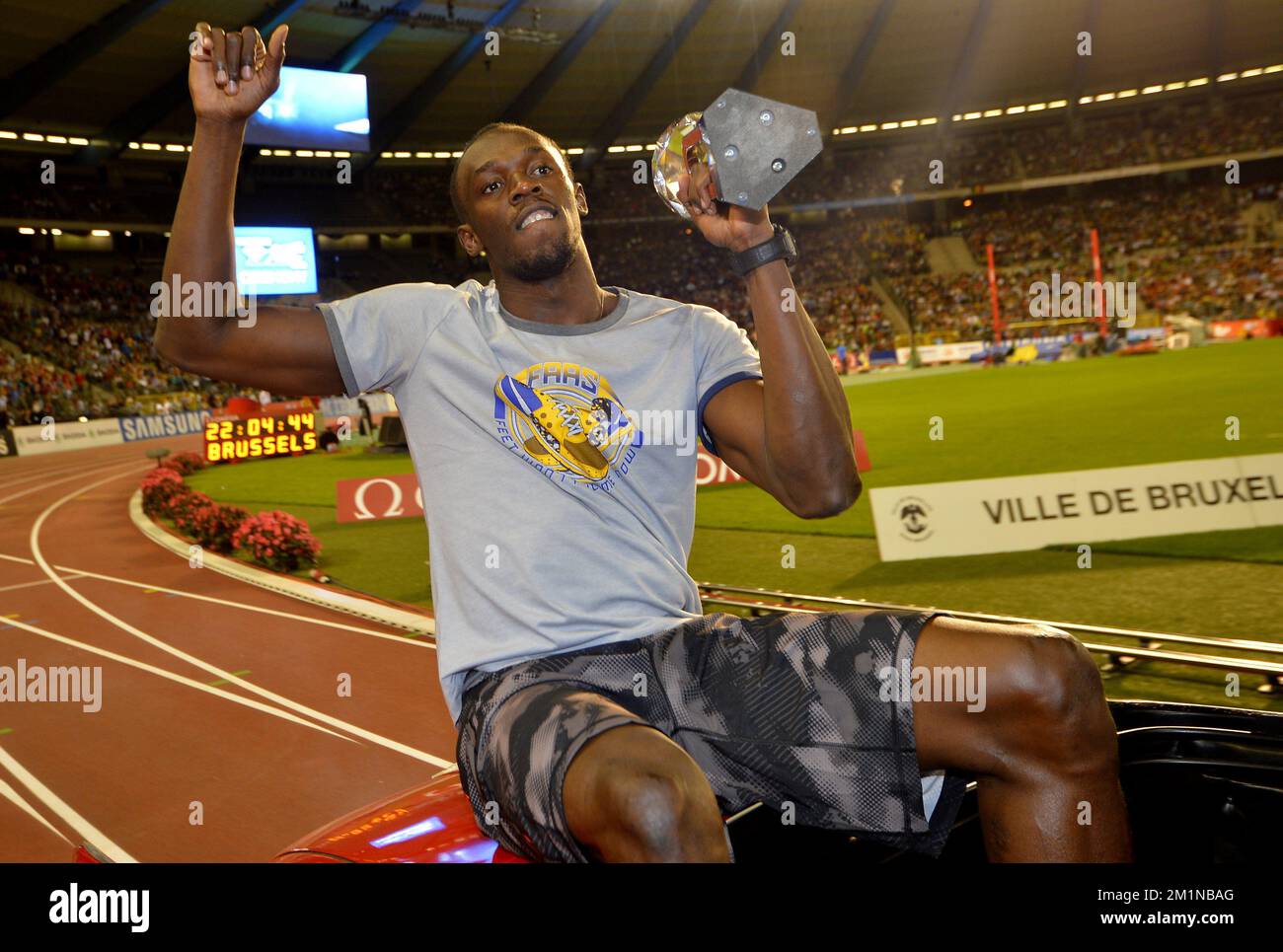 Jamaican Usain Bolt celebrates with his Diamond League trophee during a