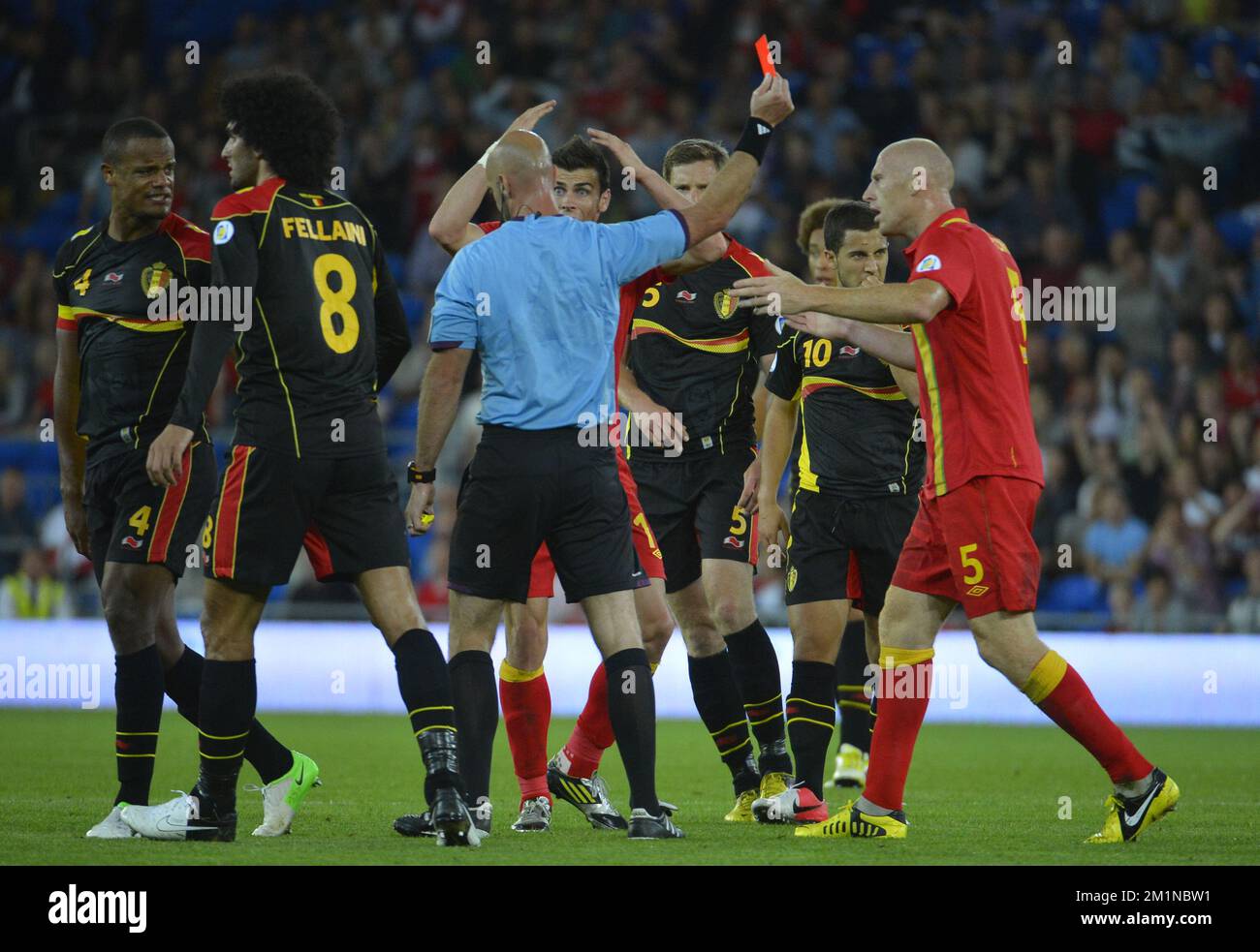 20120907 - CARDIFF, UNITED KINGDOM: Referee Stefan Johannensson gives a red card to Wales' James Collins for a severe tackle on Belgium's Guillaume Gillet during the qualifying match between Belgium Red Devils and Wales, in Cardiff, Wales, Friday 07 September 2012. This is the first of the ten qualifying games for the 2014 Soccer World Championships. BELGA PHOTO DIRK WAEM Stock Photo