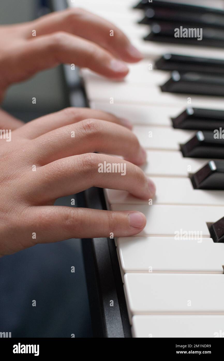 Music exercises. Piano two hands playing lessons. Keyboard closeup