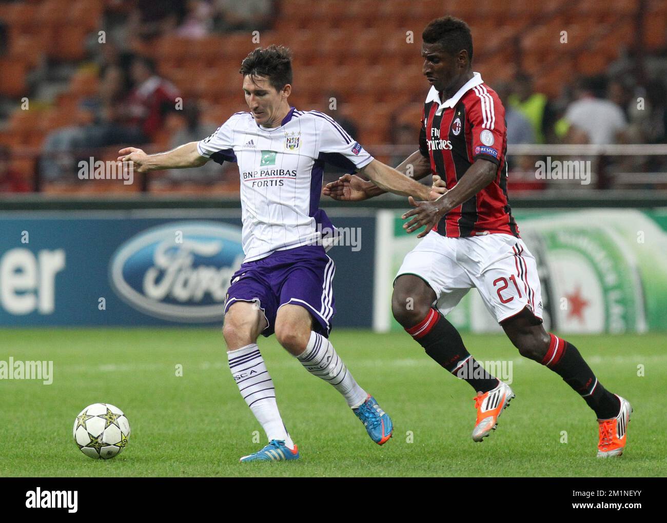 20120918 - MILAN, ITALY: Anderlecht's Sacha Kljestan and Milan's Kevin Constant fight for the ball during the UEFA Champions League Group C soccer game between Italian Associazione Calcio Milan and Belgian first division soccer team RSC Anderlecht in Milan, Italy, Tuesday 18 September 2012. BELGA PHOTO VIRGINIE LEFOUR Stock Photo