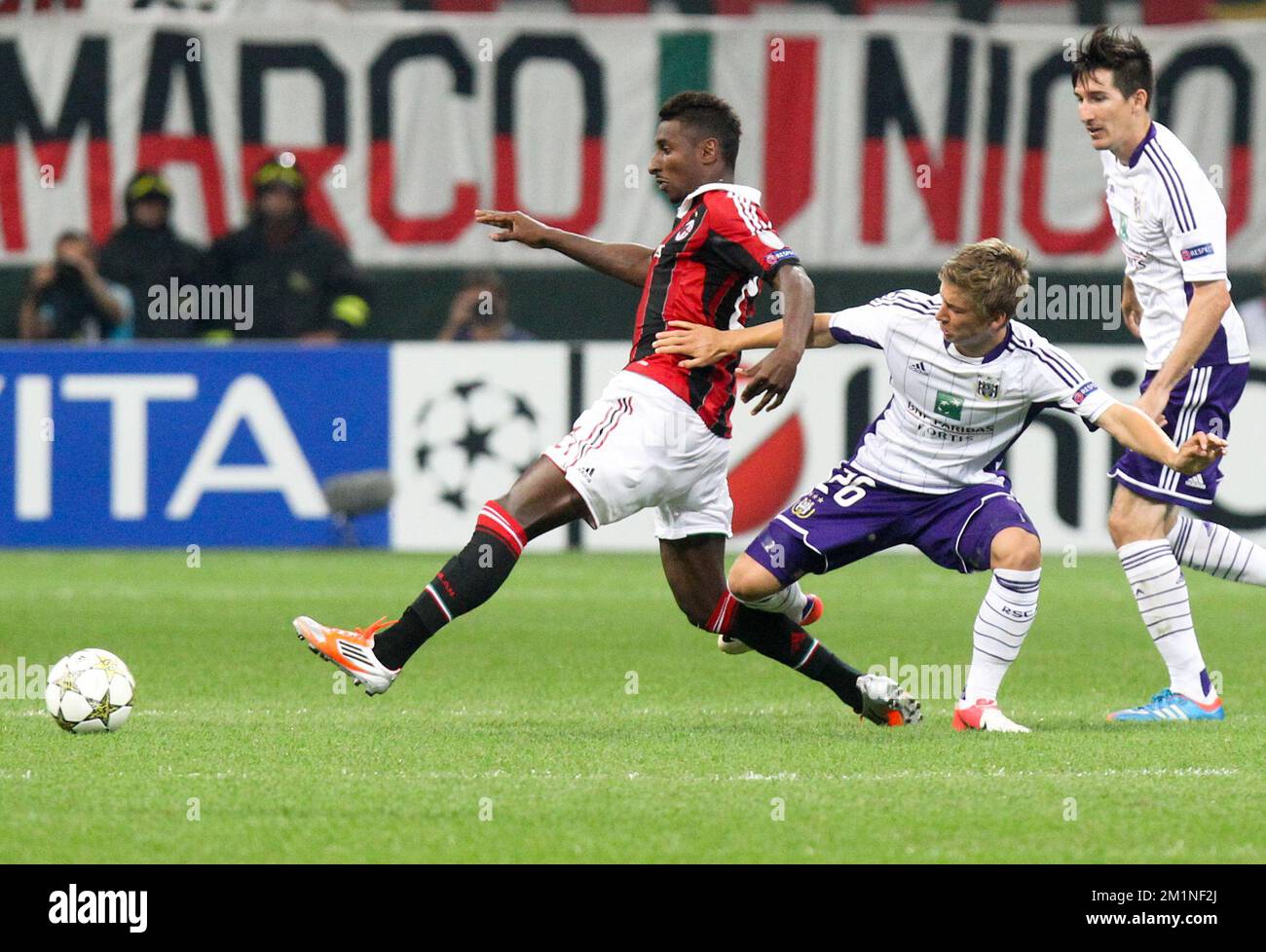 20120918 - MILAN, ITALY: Milan's Kevin Constant and Anderlecht's Dennis Praet fight for the ball during the UEFA Champions League Group C soccer game between Italian Associazione Calcio Milan and Belgian first division soccer team RSC Anderlecht in Milan, Italy, Tuesday 18 September 2012. BELGA PHOTO VIRGINIE LEFOUR Stock Photo