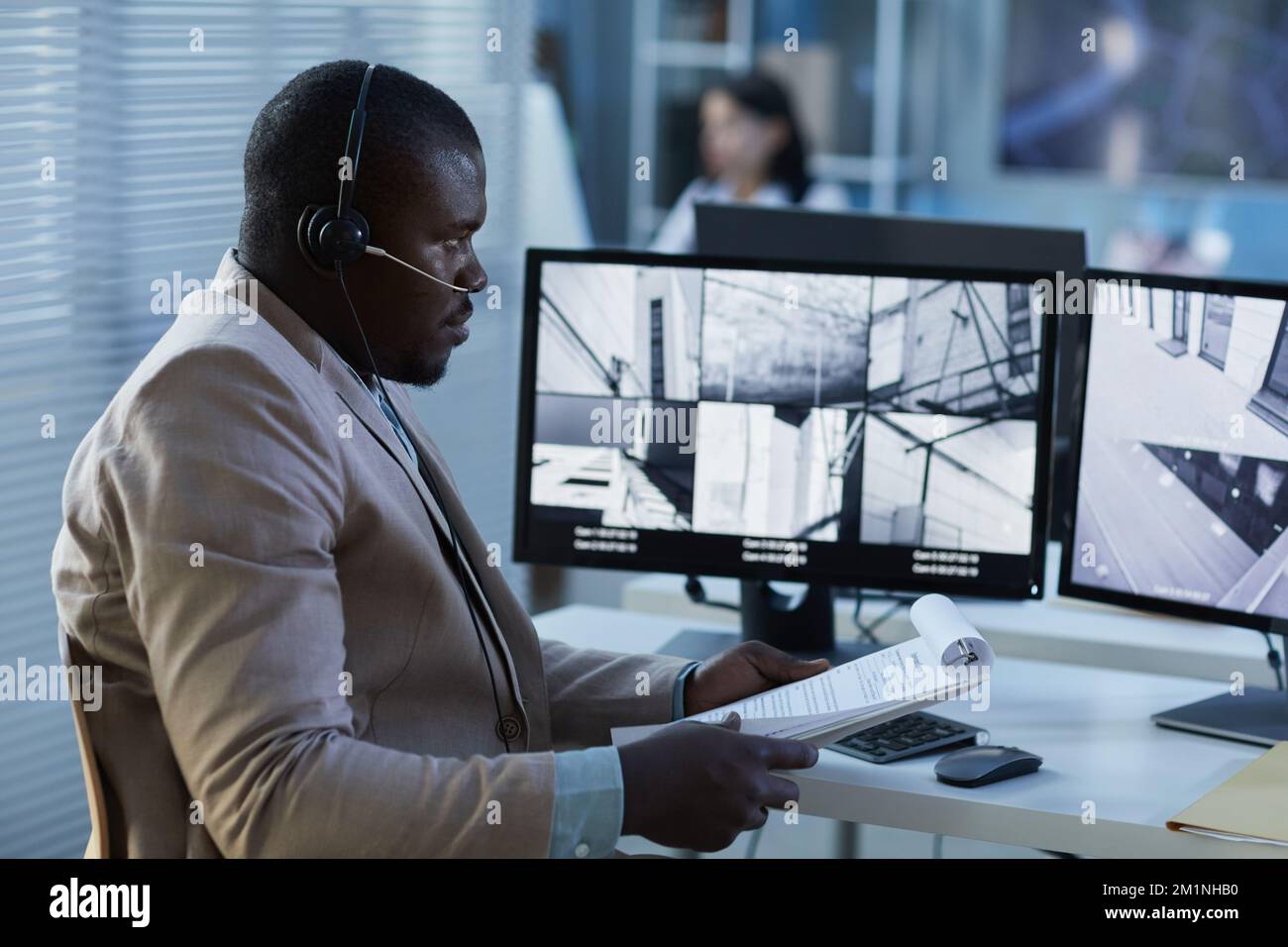 Side view portrait of black man wearing headset while watching