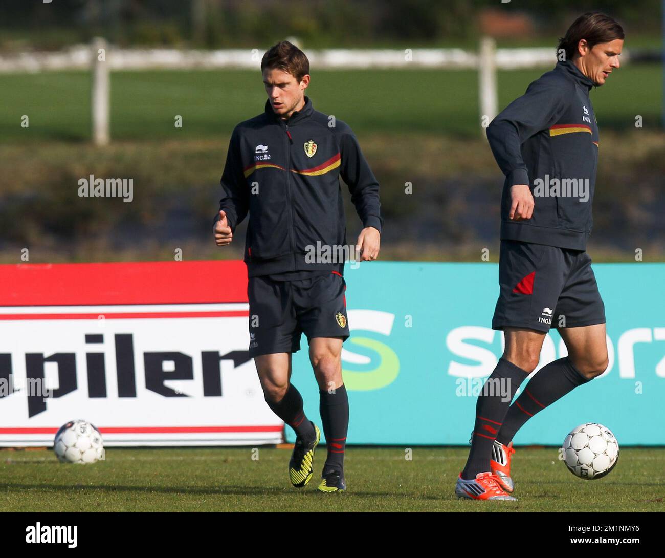 20121014 - BRUSSELS, BELGIUM: Belgium's Guillaume Gillet and Belgium's Daniel Van Buyten pictured during a training session of the Red Devils, the Belgian national soccer team, Sunday 14 October 2012 in Neerpede, Brussels. The team is preparing for a qualifying match for the 2014 Soccer World Championships, against Scotland. BELGA PHOTO VIRGINIE LEFOUR Stock Photo