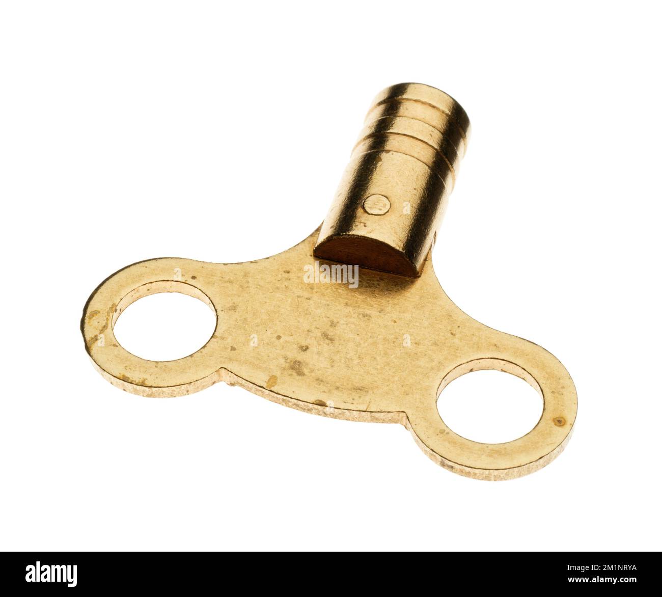A simple brass metal radiator valve key. A plumbers standard tool in their toolkit. Used to vent trapped air in a central heating system. Stock Photo