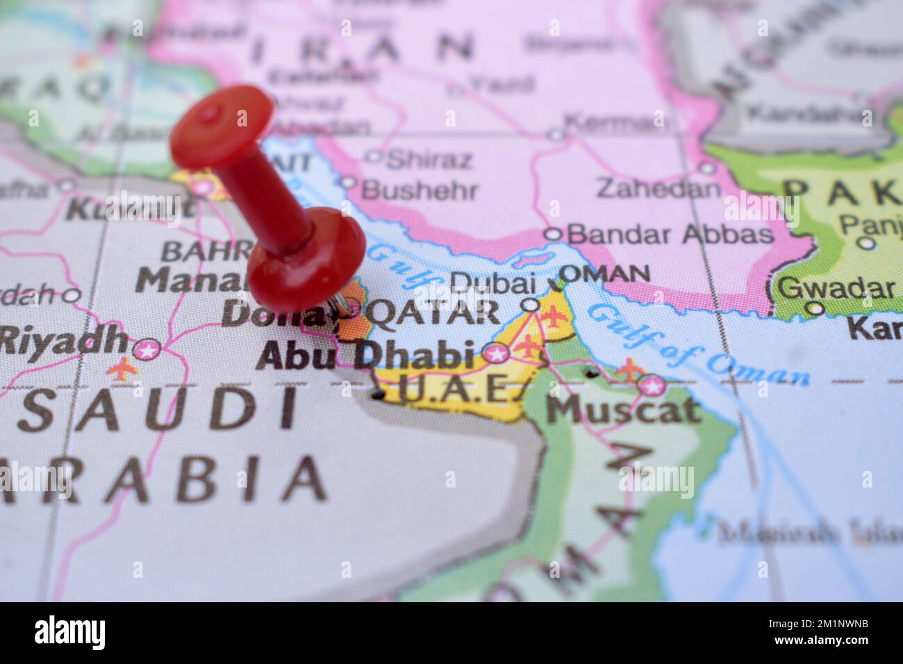 Red Push Pin Pointing on Location of Qatar World Map Close-Up View Stock Photograph Stock Photo