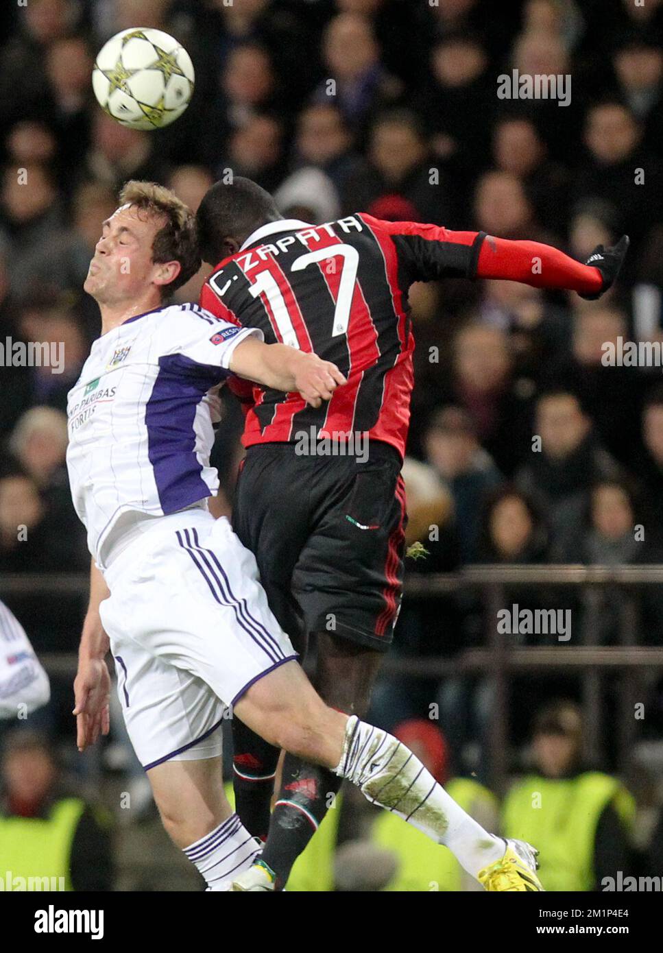 20121121 - BRUSSELS, BELGIUM: Anderlecht's Tom De Sutter and Milan's Cristian Zapata fight for the ball during the football game between Belgian RSC Anderlecht and Italian AC Milan, on the fifth day of the group C of Champions League group C Wednesday 21 November 2012 in Brussels.  BELGA PHOTO VIRGINIE LEFOUR Stock Photo