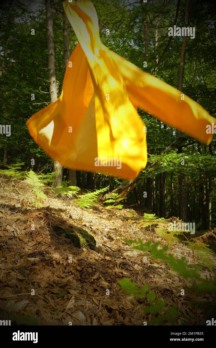 Flying yollow raincoat Stock Photo