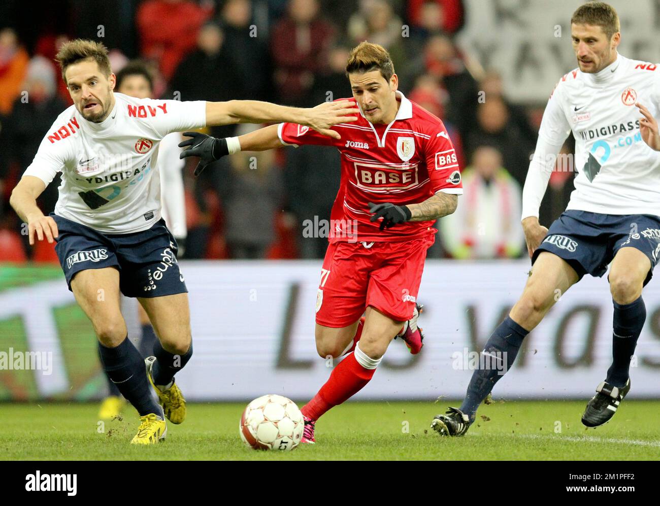 20130125 - LIEGE, BELGIUM: Kortrijk's Romain Reynaud and Standard's Maor Bar Buzaglo fight for the ball during the Jupiler Pro League match between Standard de Liege and KV Kortrijk, in Liege, Friday 25 January 2013, on day 24 of the Belgian soccer championship. BELGA PHOTO VIRGINIE LEFOUR Stock Photo