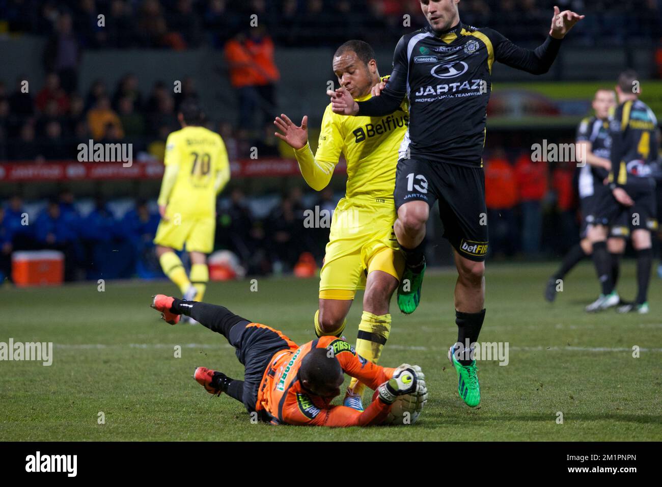 Lokeren's goalkeeper Barry Boubacar Copa, Club Brugge's Vadis Odjidja Ofoe and Lokeren's Georgios Galitsios fight for the ball during the Jupiler Pro League match of Play-Off 1, between Sporting Lokeren and Club Brugge in Lokeren Stock Photo
