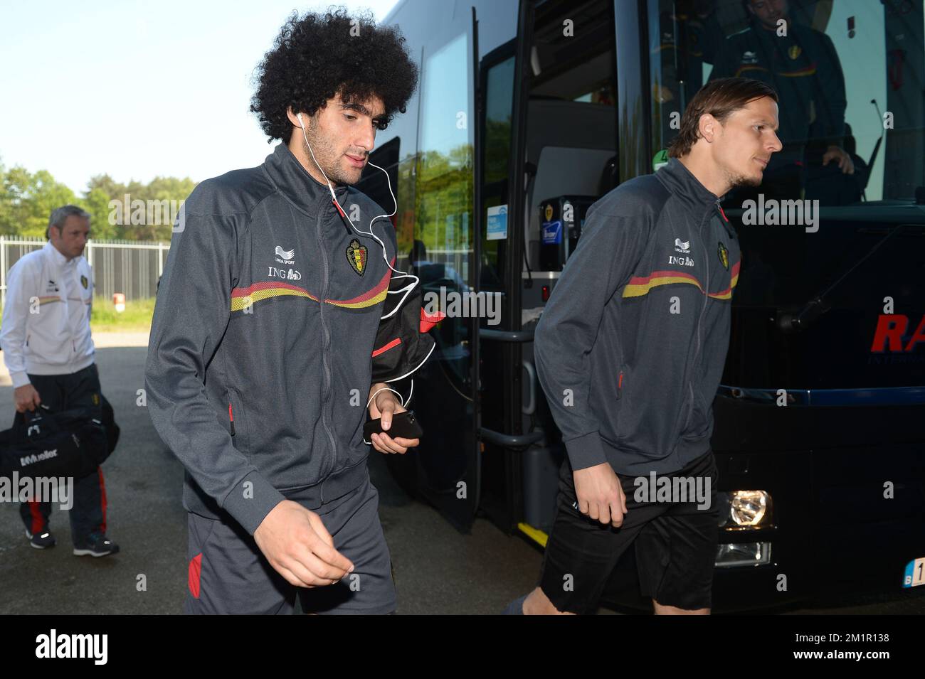 Belgium's Marouane Fellaini and Belgium's Daniel Van Buyten (right) arrive for a training session of the Belgium national soccer team, Wednesday 05 June 2013 in Genk. The Red Devils are preparing for their qualification game for the 2014 FIFA World Cup against Serbia on June 7. Stock Photo