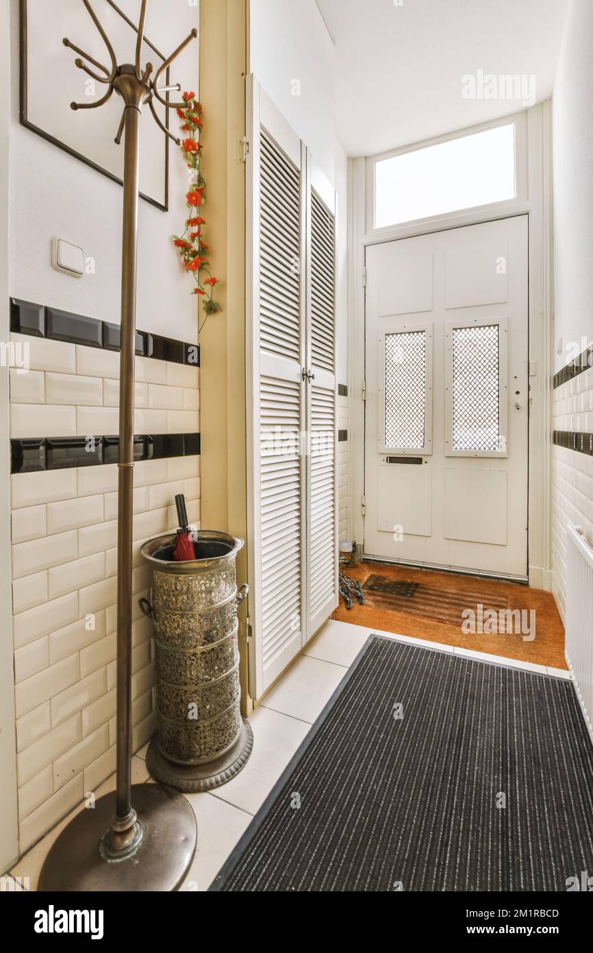 a hallway in a house with white walls and black trim around the door