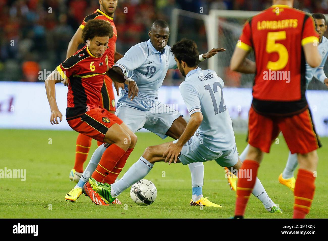 Belgium's Axel Witsel, French Josuha Guilavogui and French Clement Grenier fight for the ball during a friendly game of the Belgian national soccer team Red Devils against France's national soccer team, Wednesday 14 August 2013, in the King Baudouin Stadium (Stade Roi Baudouin/Koning Boudewijnstadion), in Brussels.  Stock Photo